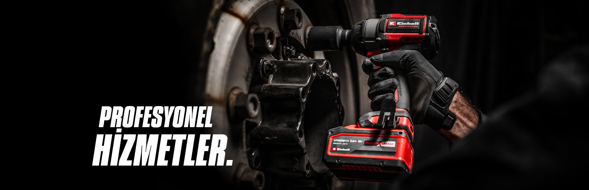 Close-up of a red cordless impact wrench being used on a wheel, with the text "Professional Services".