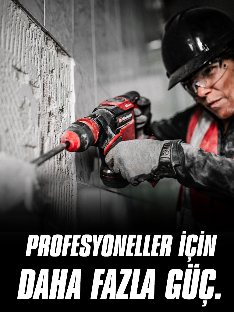 A person wearing safety glasses and a helmet uses a red drill on a wall, with the text "More Power for Pros".