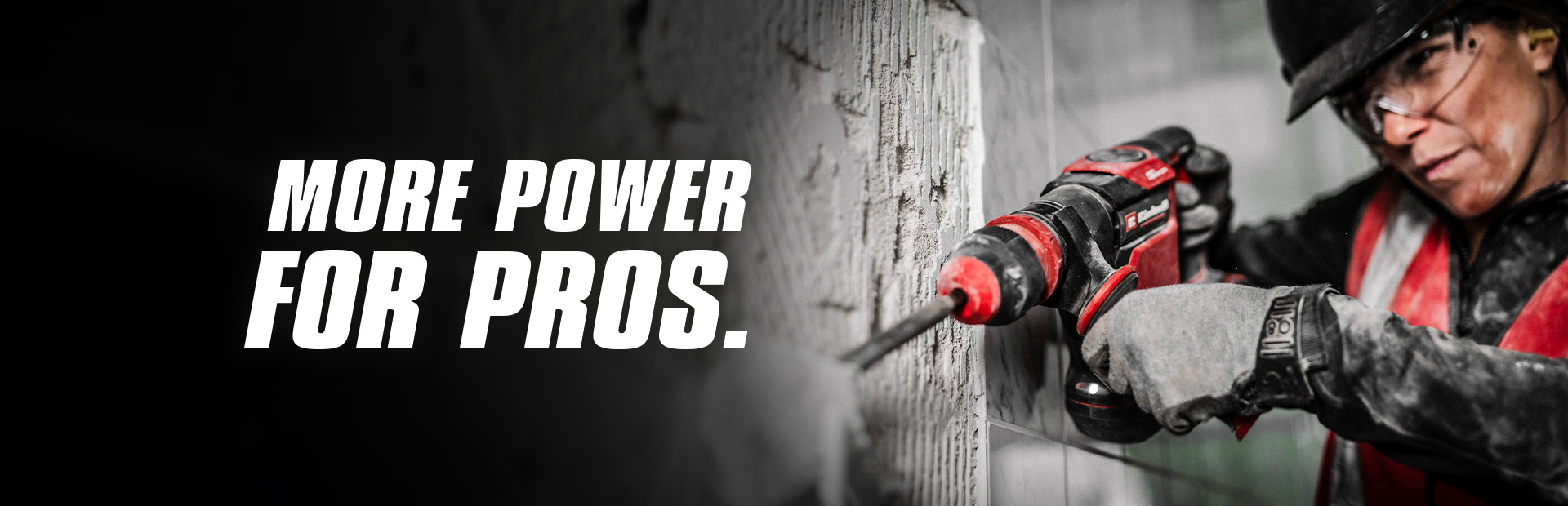 A person wearing safety glasses and a helmet uses a red drill on a wall, with the text "More Power for Pros".