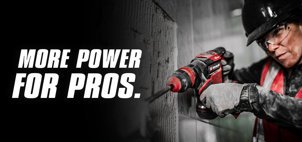 A person wearing safety glasses and a helmet uses a red drill on a wall, with the text "More Power for Pros".